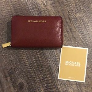 Red Michael Kors wallet with gold color zipper